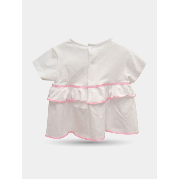 Retro del top bianco con bottoncini e balza bordata di rosa