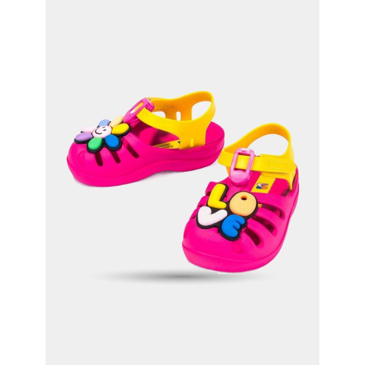 Ciabatte Ipanema fucsia con fiore sorridente, viste di lato