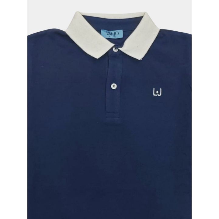 Dettaglio del colletto bianco panna e del logo LJ ricamato sulla polo blu