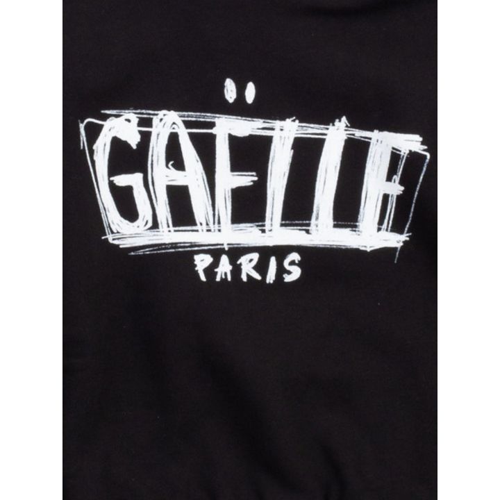 Dettaglio del logo Gaelle Paris in bianco tracciato a mano