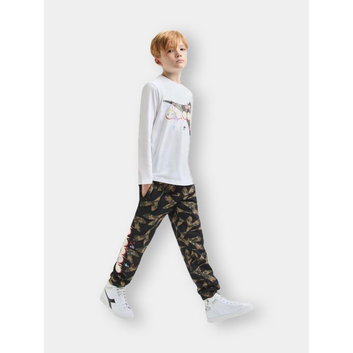 Ragazzo in movimento con la t-shirt Diadora bianca, vista laterale