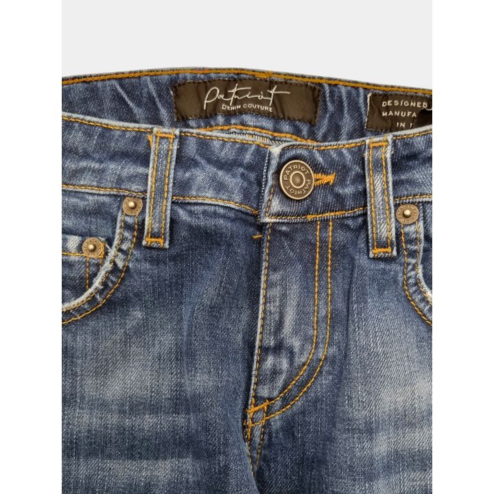 Dettaglio del bottone logato e dell'etichetta interna dei jeans Patriot blu