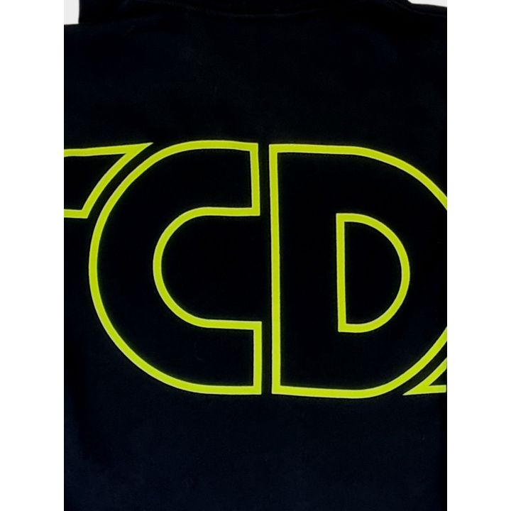 Dettaglio del maxi logo GCDS giallo fluo a lettere vuote sul retro