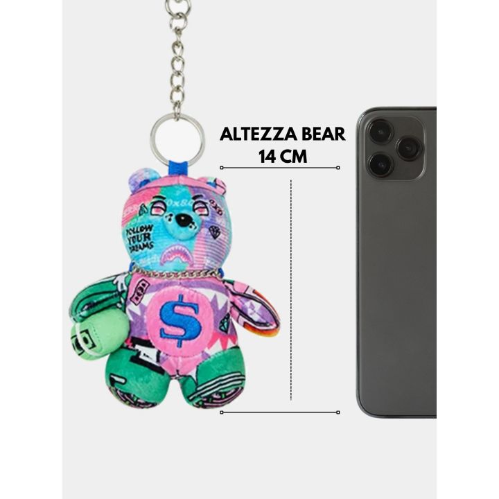 Portachiavi orsetto Sprayground accanto a uno smartphone per l'altezza