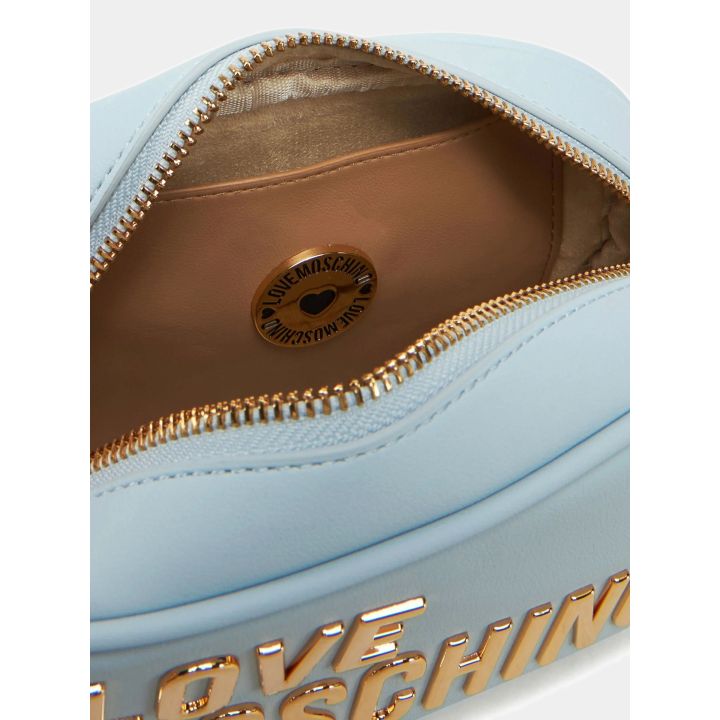 Interno della borsa azzurra con zip aperta e fodera color sabbia